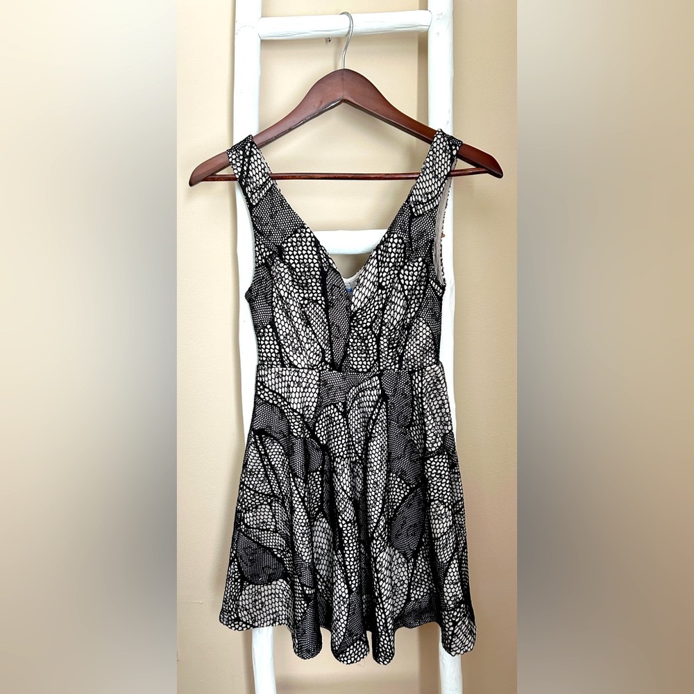 Size Small, black and cream with sequins through the black detail